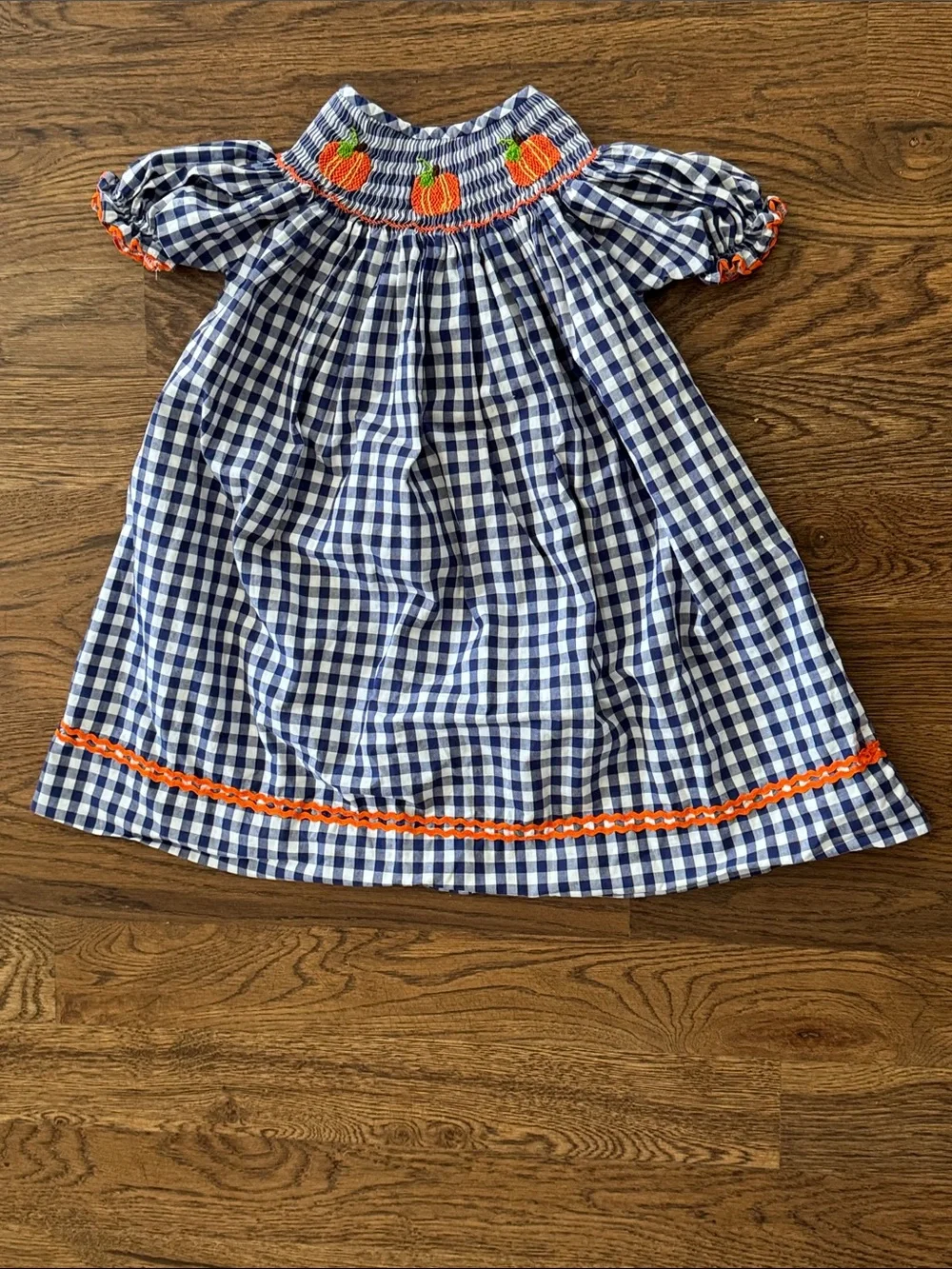 Cecil And Lou Navy Gingham Smocked Dress with Smocked Orange Pumpkin Embroidery